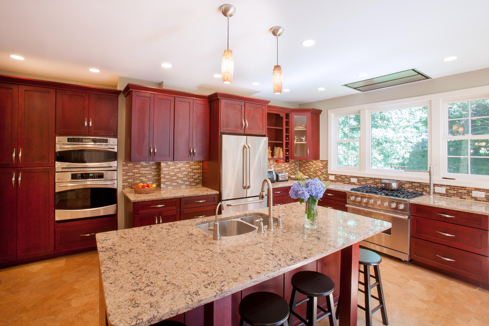 Photo of a large traditional l-shaped kitchen in DC Metro with mosaic tile splashback, brown splashback, an undermount sink, flat-panel cabinets, stainless steel appliances, cork floors, with island, dark wood cabinets and brown floor.