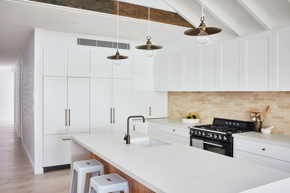 This is an example of a beach style kitchen in Sydney.