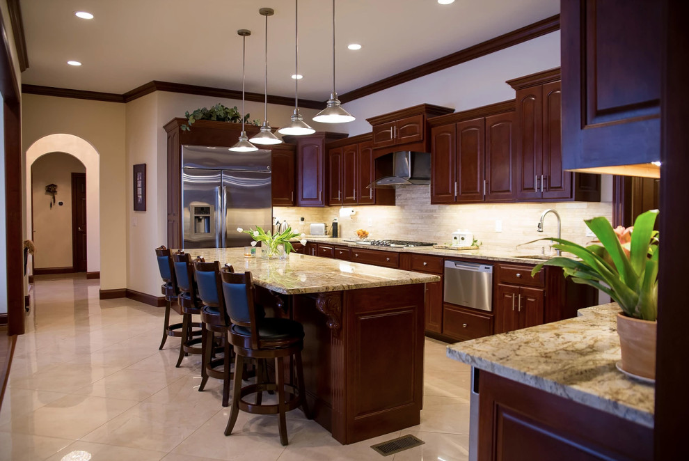 Large minimalist u-shaped porcelain tile and beige floor open concept kitchen photo with an undermount sink, raised-panel cabinets, dark wood cabinets, granite countertops, beige backsplash, matchstick tile backsplash, stainless steel appliances, an island and multicolored countertops