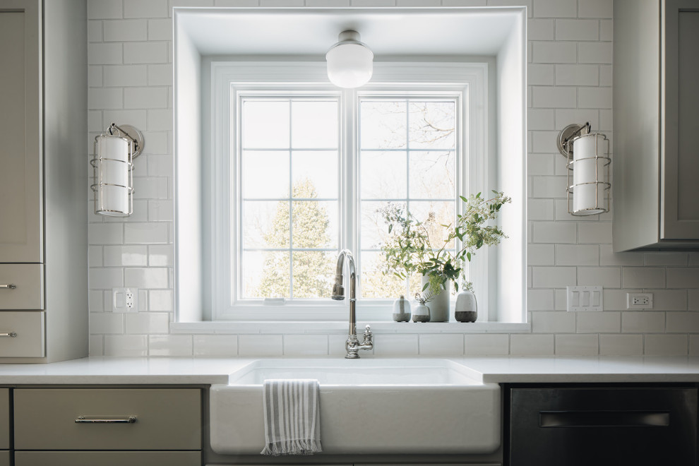 Example of a mid-sized transitional dark wood floor eat-in kitchen design in Chicago with a farmhouse sink, shaker cabinets, gray cabinets, quartz countertops, white backsplash, ceramic backsplash, paneled appliances, an island and white countertops