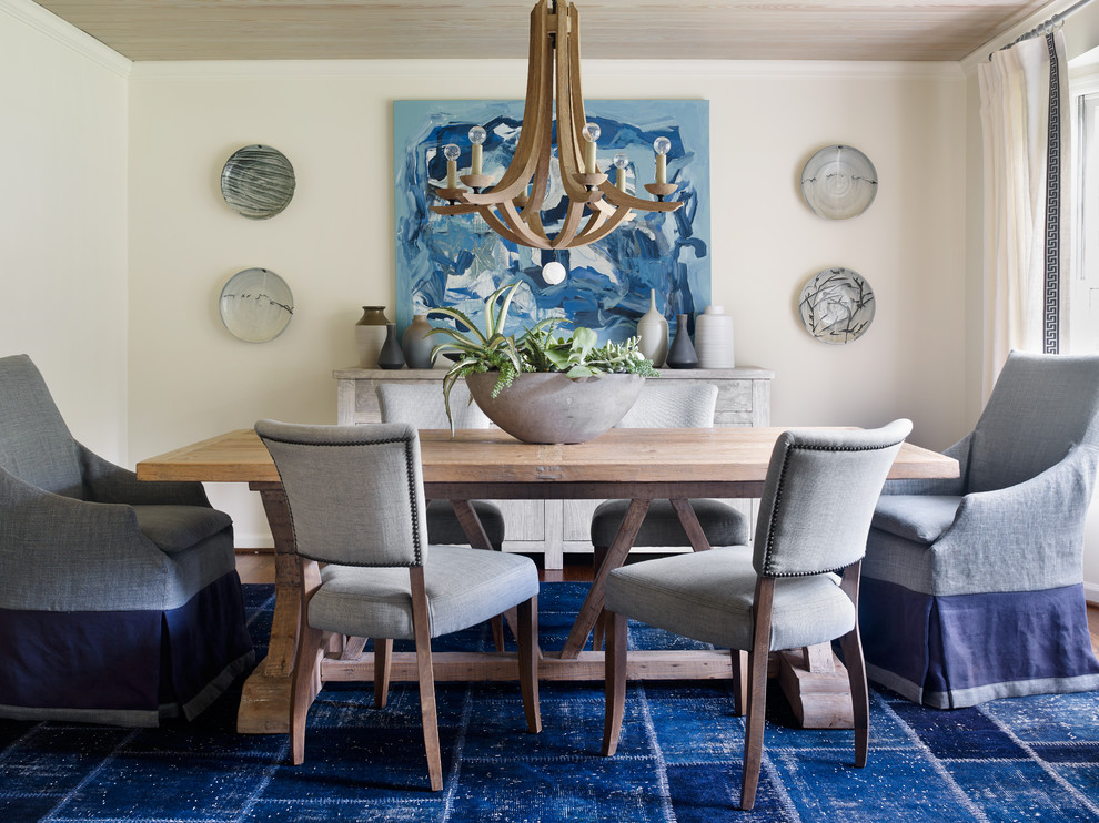 This is an example of an eclectic dining room in Atlanta with beige walls and carpet.