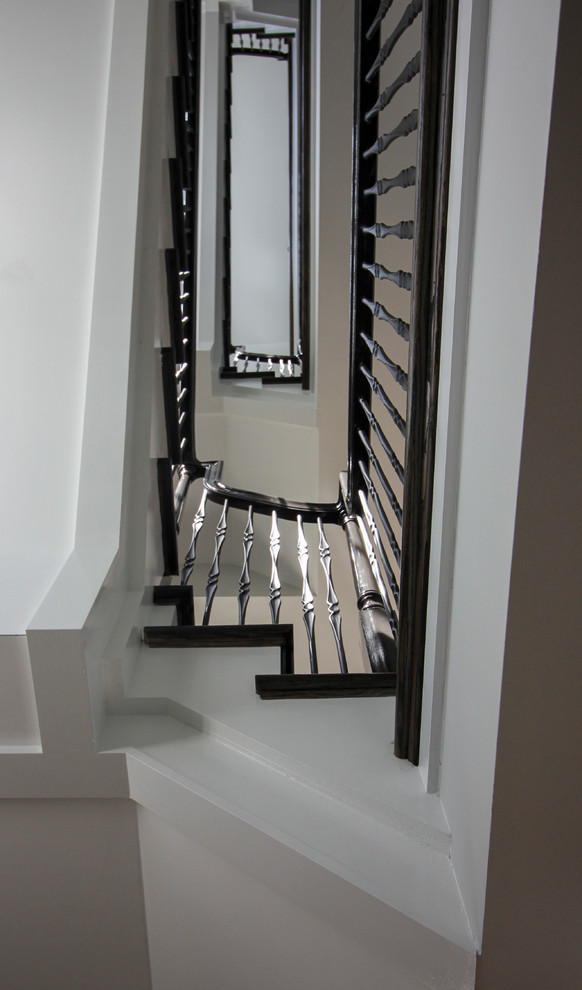 Inspiration for a large transitional wooden l-shaped mixed material railing staircase remodel in DC Metro with painted risers