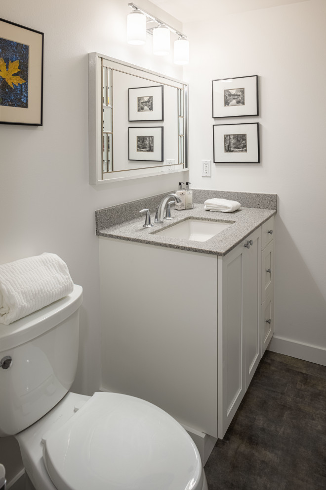 Inspiration for a mid-sized transitional 3/4 bathroom in Detroit with white cabinets, white walls, an undermount sink, a single vanity, a built-in vanity, shaker cabinets, an alcove shower, a two-piece toilet, porcelain floors, engineered quartz benchtops, grey floor, a shower curtain and grey benchtops.