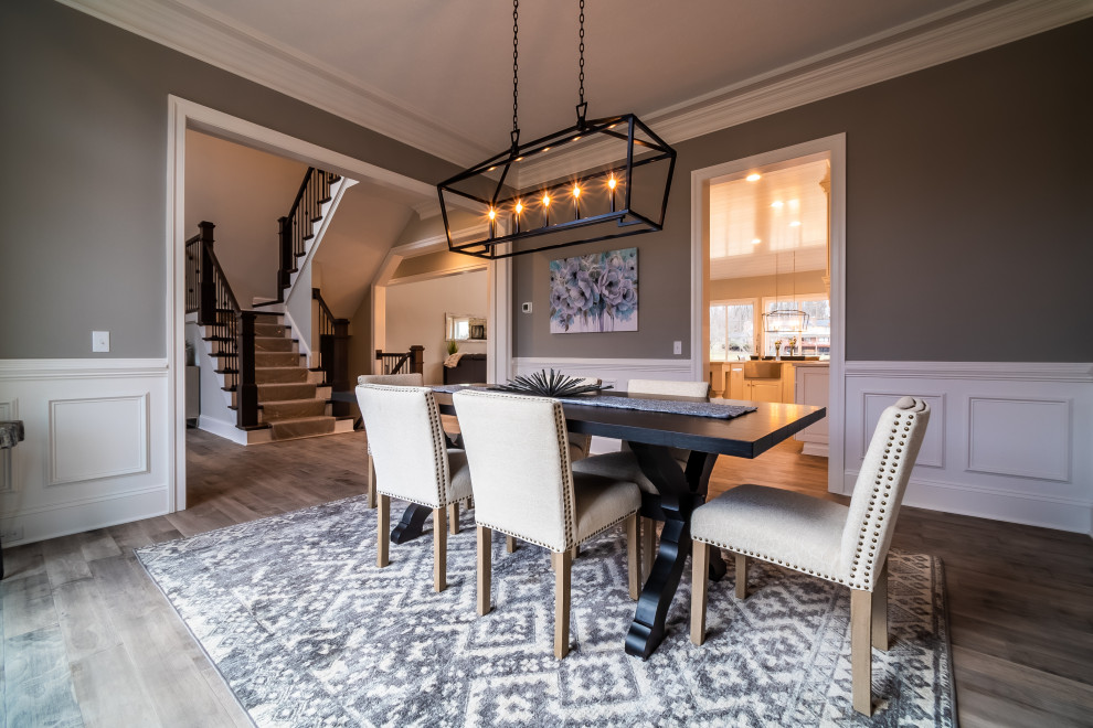 Example of a transitional light wood floor dining room design with beige walls