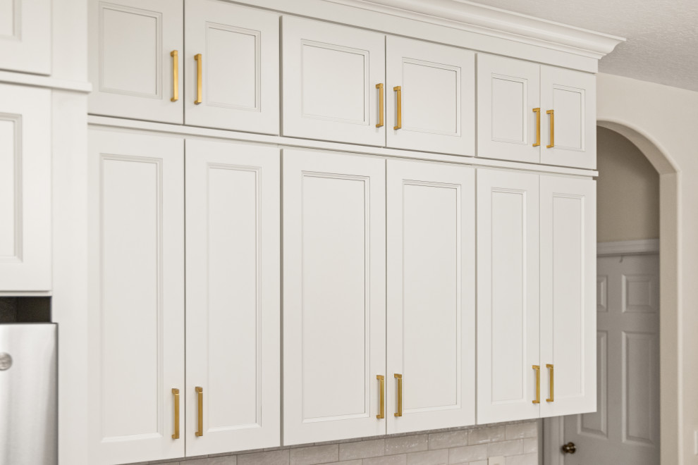 Eat-in kitchen - small transitional l-shaped light wood floor and multicolored floor eat-in kitchen idea in Tampa with an undermount sink, shaker cabinets, beige cabinets, quartzite countertops, beige backsplash, porcelain backsplash, stainless steel appliances, a peninsula and white countertops
