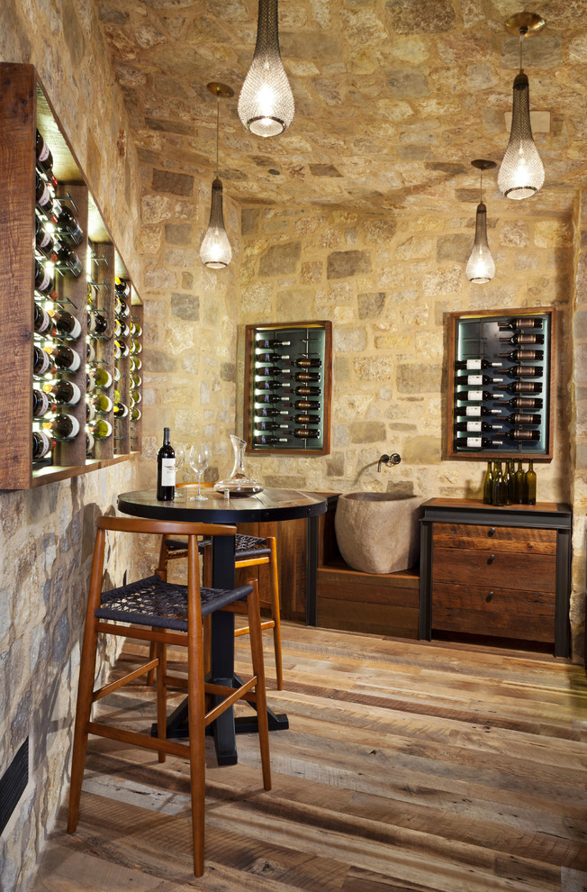 Design ideas for a mid-sized country wine cellar in Denver with display racks.