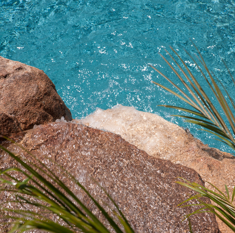 Mountain style backyard concrete paver and custom-shaped natural pool fountain photo in Phoenix
