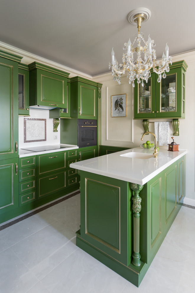 This is an example of a small traditional galley kitchen in Moscow with an integrated sink, raised-panel cabinets, green cabinets, solid surface benchtops, white splashback, marble splashback, black appliances, porcelain floors, beige floor, white benchtop and a peninsula.