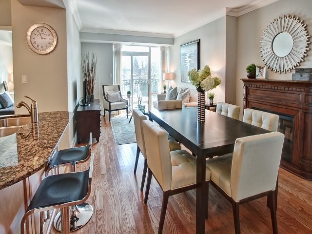 Transitional light wood floor great room photo in Toronto with gray walls, a standard fireplace and a wood fireplace surround