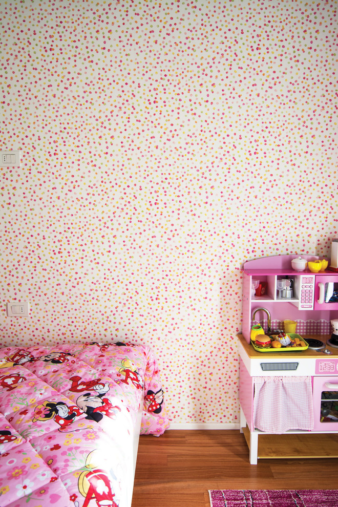Design ideas for a small contemporary kids' room for girls in Florence with multi-coloured walls and painted wood floors.