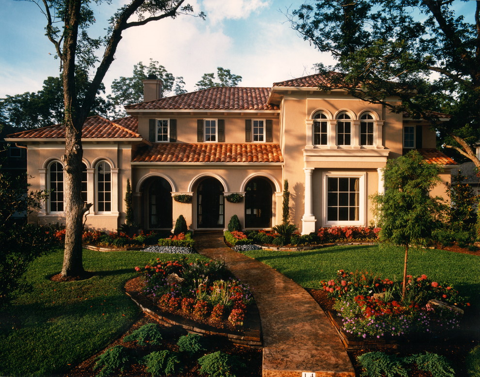 Design ideas for a mediterranean two-storey exterior in Houston with a tile roof.
