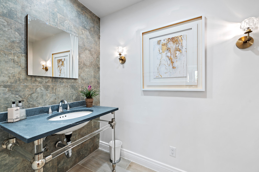 This is an example of a contemporary powder room in Orange County with gray tile, white walls, an undermount sink, beige floor and blue benchtops.