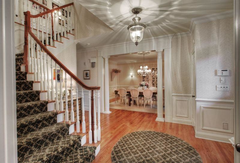 Inspiration for a mid-sized transitional foyer in Las Vegas with yellow walls, medium hardwood floors, a single front door and a medium wood front door.