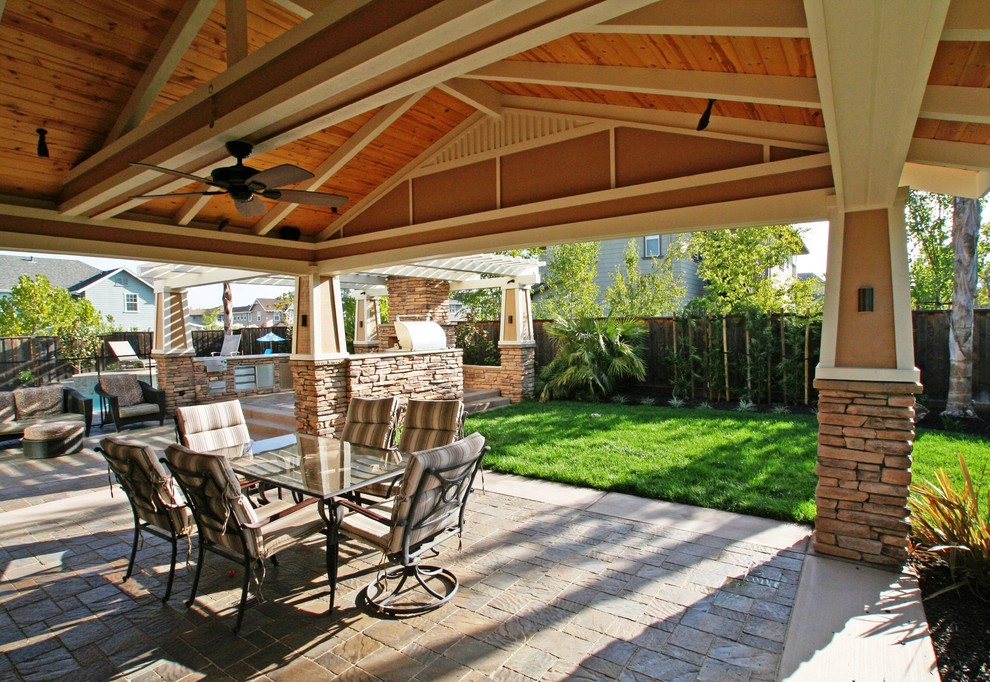 This is an example of a mid-sized traditional backyard patio in San Francisco with concrete pavers and a gazebo/cabana.
