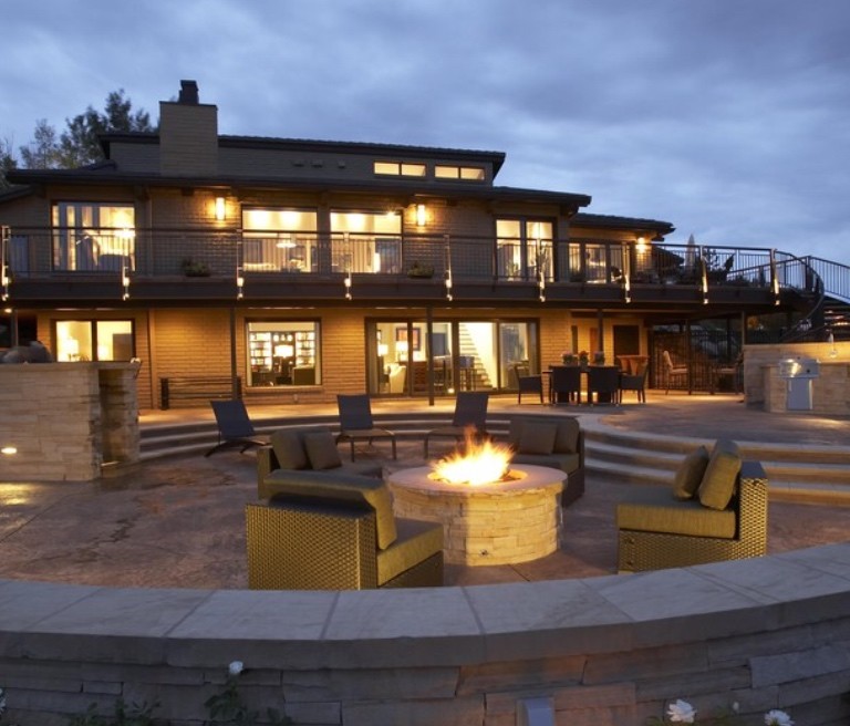 This is an example of a large contemporary backyard patio in Denver with a fire feature, concrete slab and no cover.