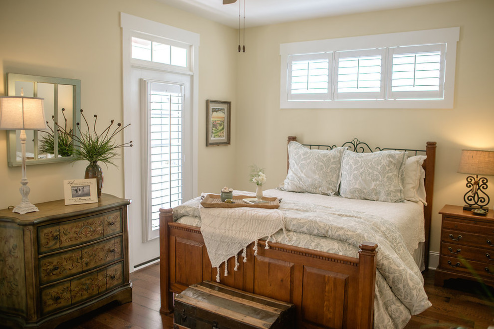 Photo of a mid-sized arts and crafts guest bedroom in Other with beige walls and medium hardwood floors.