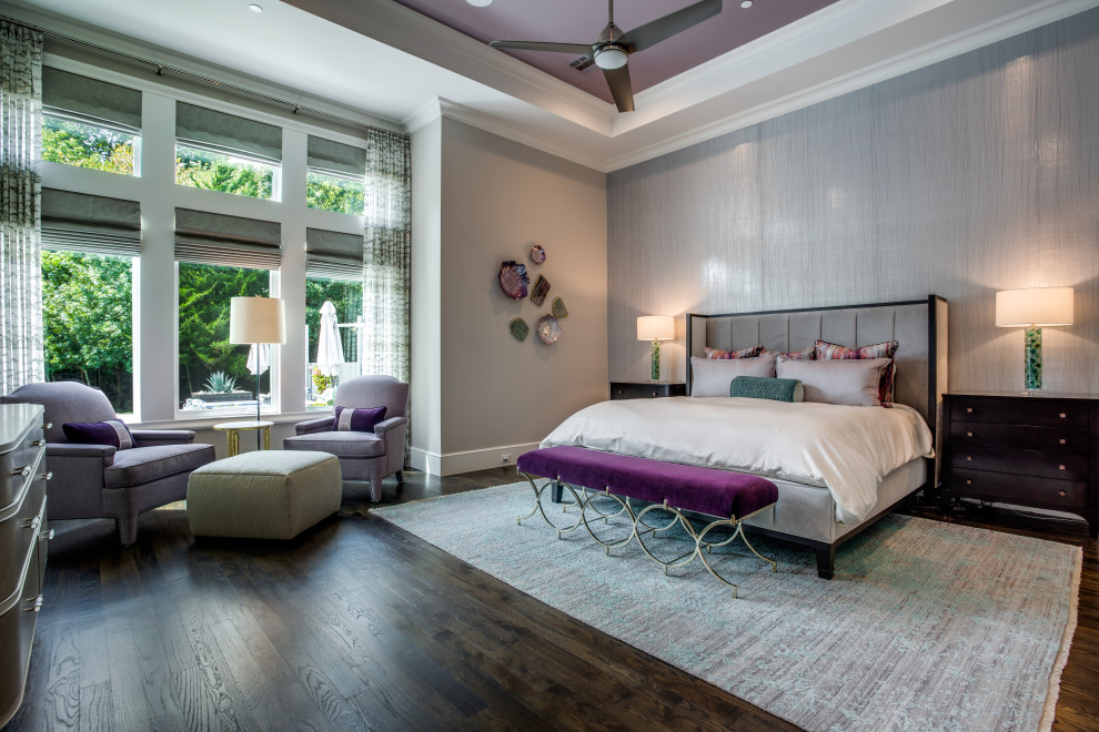 This is an example of a large transitional master bedroom in Dallas with grey walls, medium hardwood floors, no fireplace, brown floor, recessed and wallpaper.