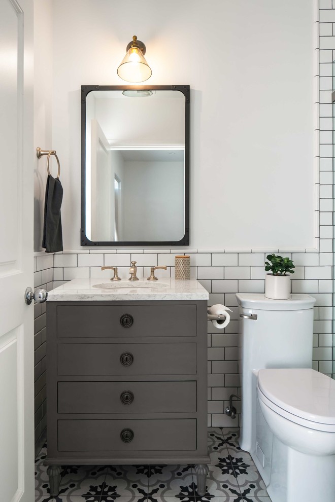 Design ideas for a small industrial 3/4 bathroom in Los Angeles with grey cabinets, a one-piece toilet, white tile, subway tile, white walls, porcelain floors, an undermount sink, marble benchtops, grey floor, white benchtops, furniture-like cabinets, an alcove shower and a hinged shower door.