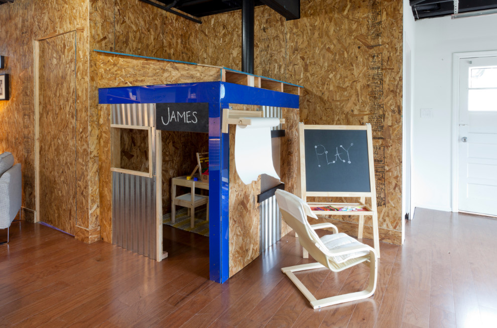 Playroom - industrial gender-neutral medium tone wood floor playroom idea in New York