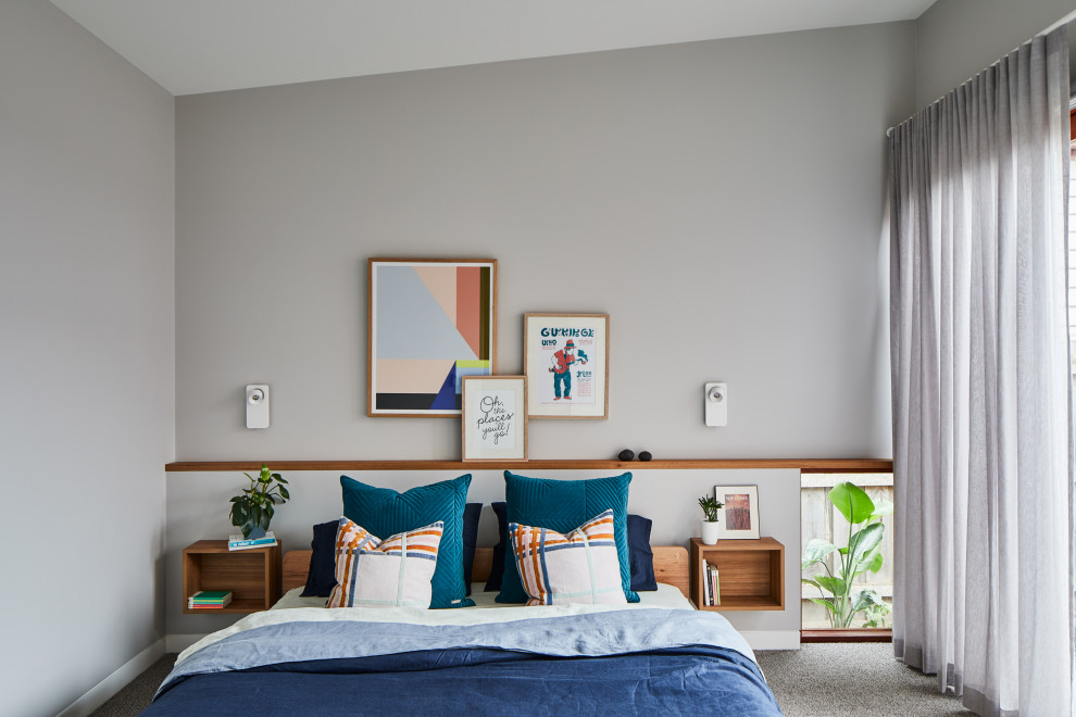 Contemporary bedroom in Melbourne with grey walls, carpet, grey floor and vaulted.
