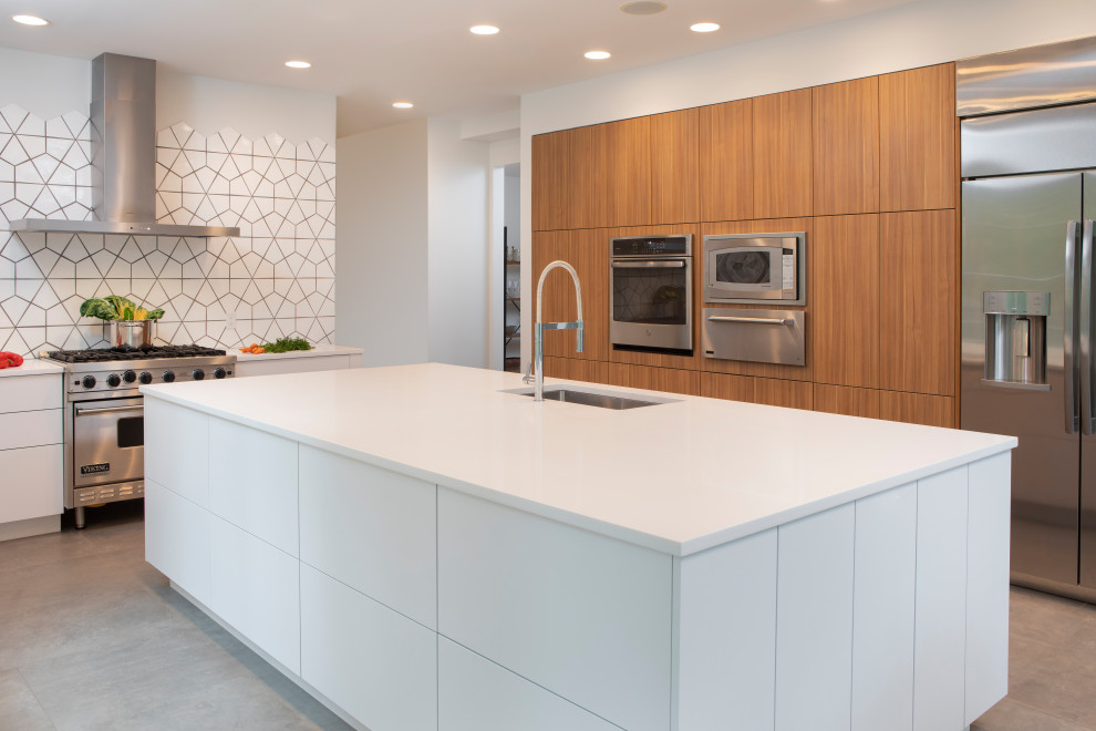 Design ideas for a large contemporary l-shaped separate kitchen in New York with a drop-in sink, flat-panel cabinets, white cabinets, quartz benchtops, yellow splashback, mosaic tile splashback, stainless steel appliances, medium hardwood floors, with island, brown floor and white benchtop.