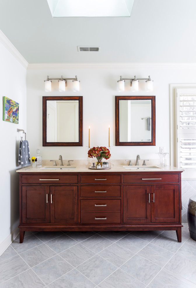 Design ideas for a mid-sized traditional master bathroom in Charlotte with an undermount sink, shaker cabinets, medium wood cabinets, marble benchtops, an alcove tub, an alcove shower, a two-piece toilet, gray tile, porcelain tile, beige walls, travertine floors, grey floor and beige benchtops.