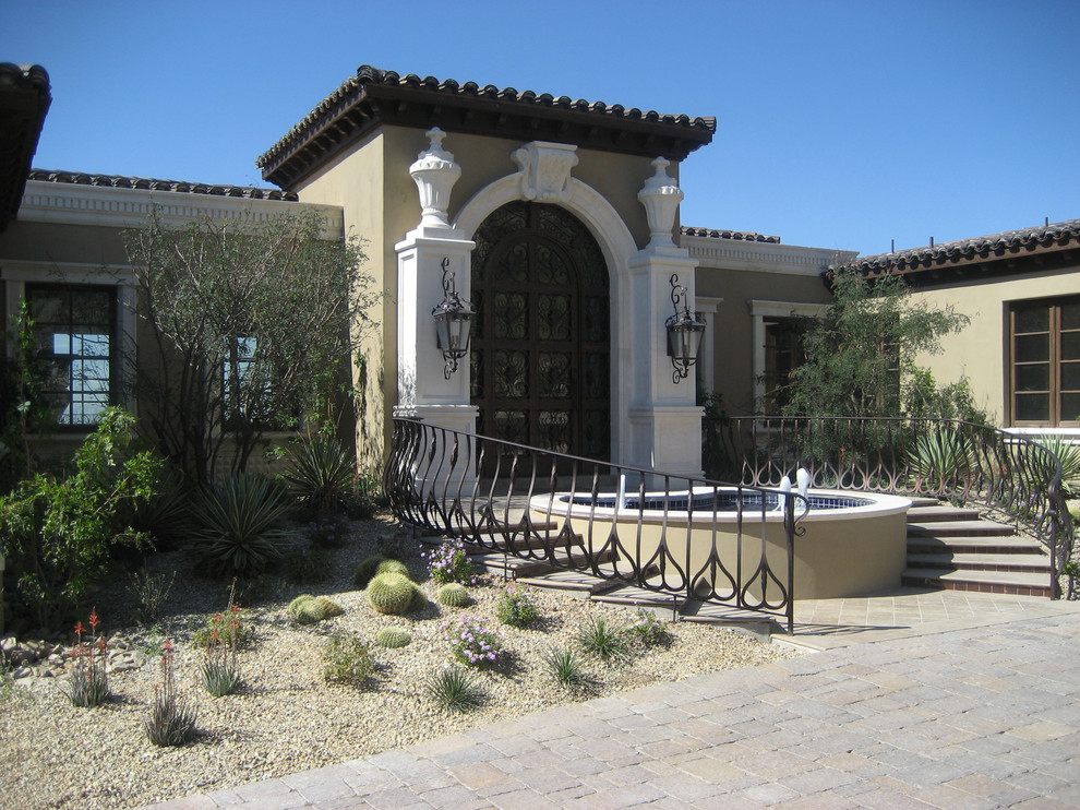 This is an example of a mediterranean entryway in Phoenix with a double front door.