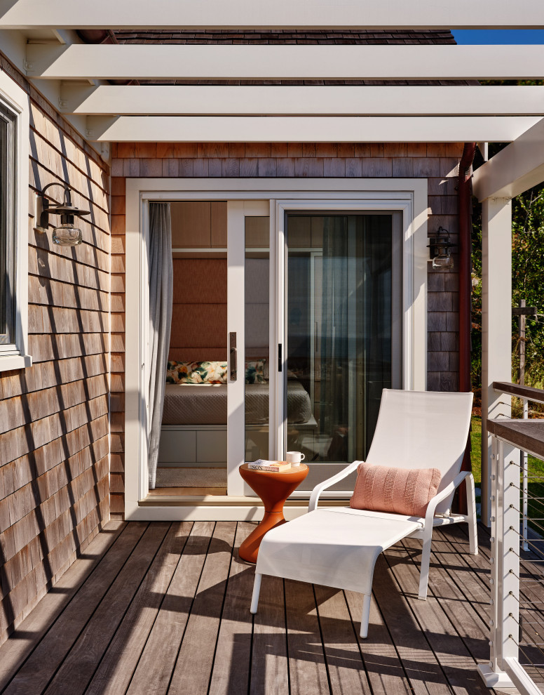 Mid-sized beach style side yard ground level cable railing deck photo in Boston with a pergola