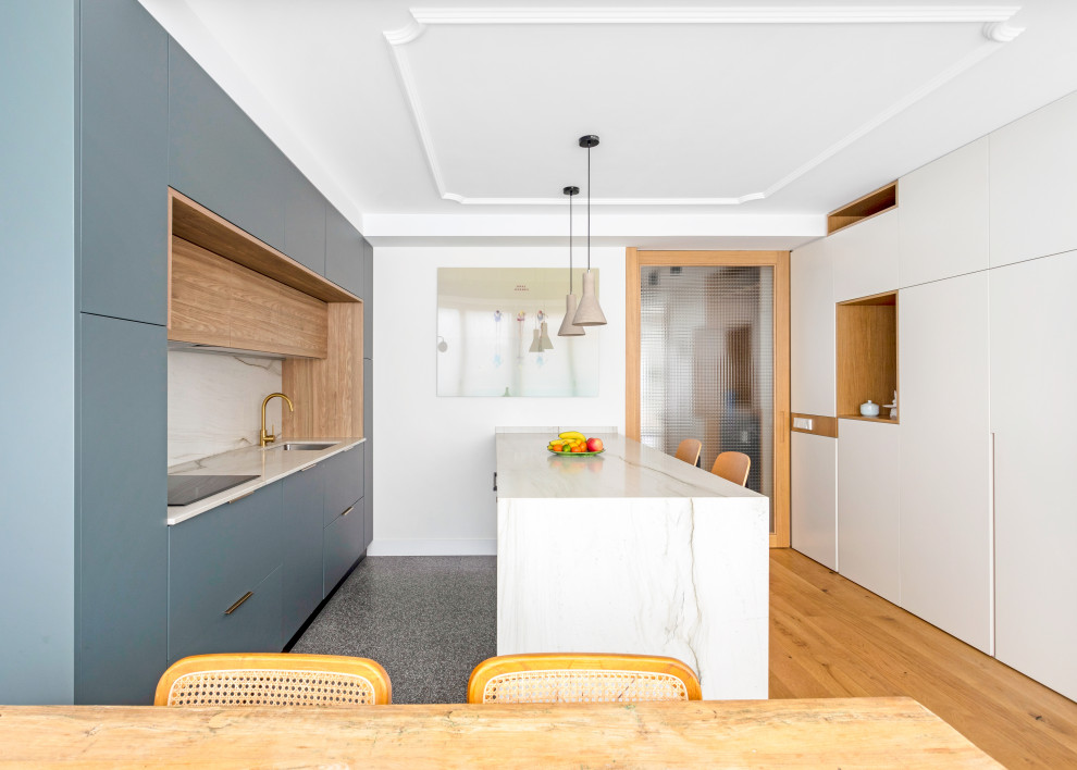 Design ideas for a contemporary galley eat-in kitchen in Madrid with an undermount sink, flat-panel cabinets, white cabinets, marble benchtops, multi-coloured splashback, marble splashback, panelled appliances, medium hardwood floors, with island, brown floor and multi-coloured benchtop.
