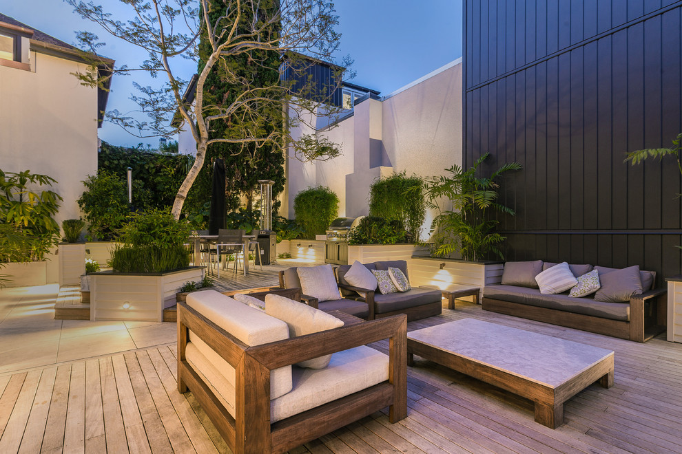 Photo of a large transitional deck in Auckland with a container garden and no cover.