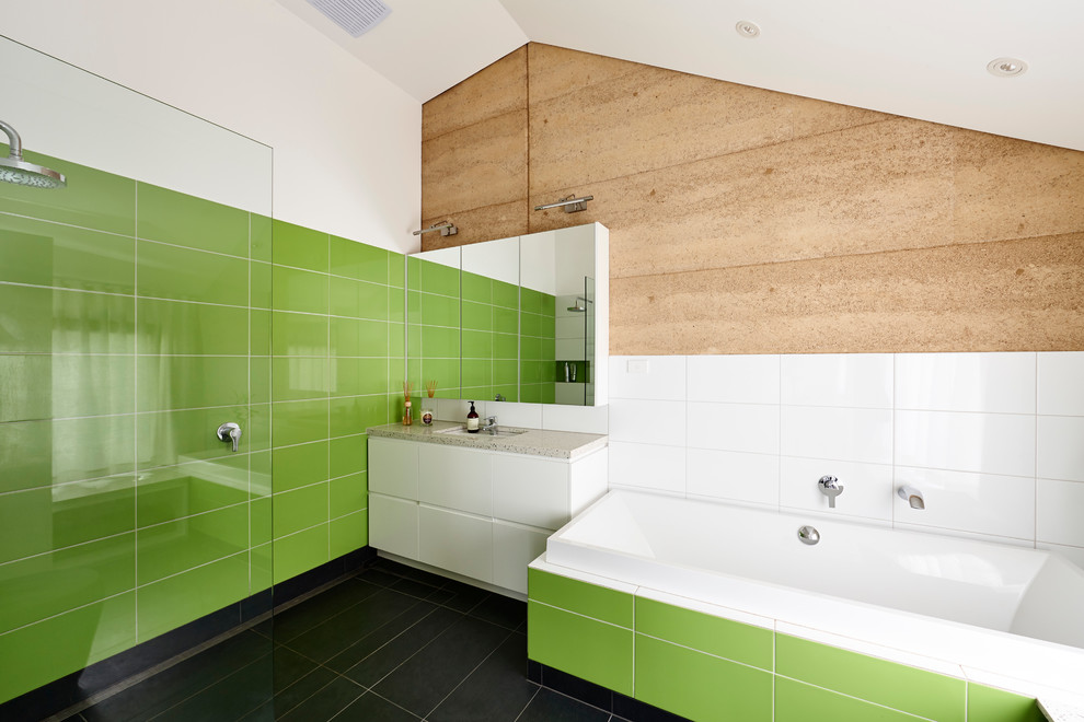 Mid-sized contemporary master bathroom in Melbourne with an undermount sink, flat-panel cabinets, white cabinets, a drop-in tub, an open shower, green tile, white walls, engineered quartz benchtops, a one-piece toilet, ceramic tile, ceramic floors and an open shower.