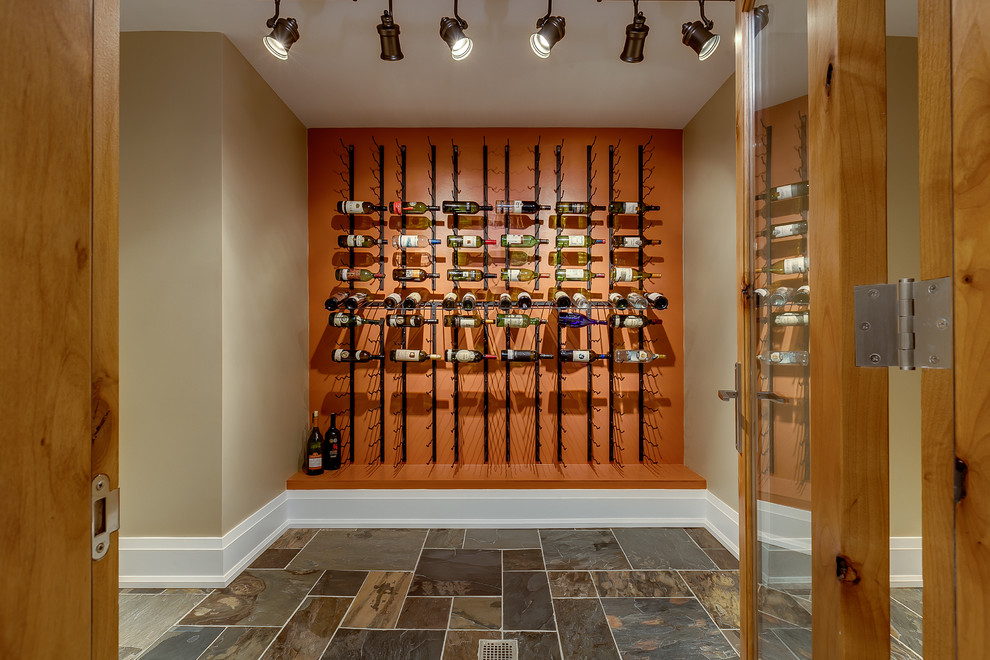 This is an example of a transitional wine cellar in Toronto with storage racks.