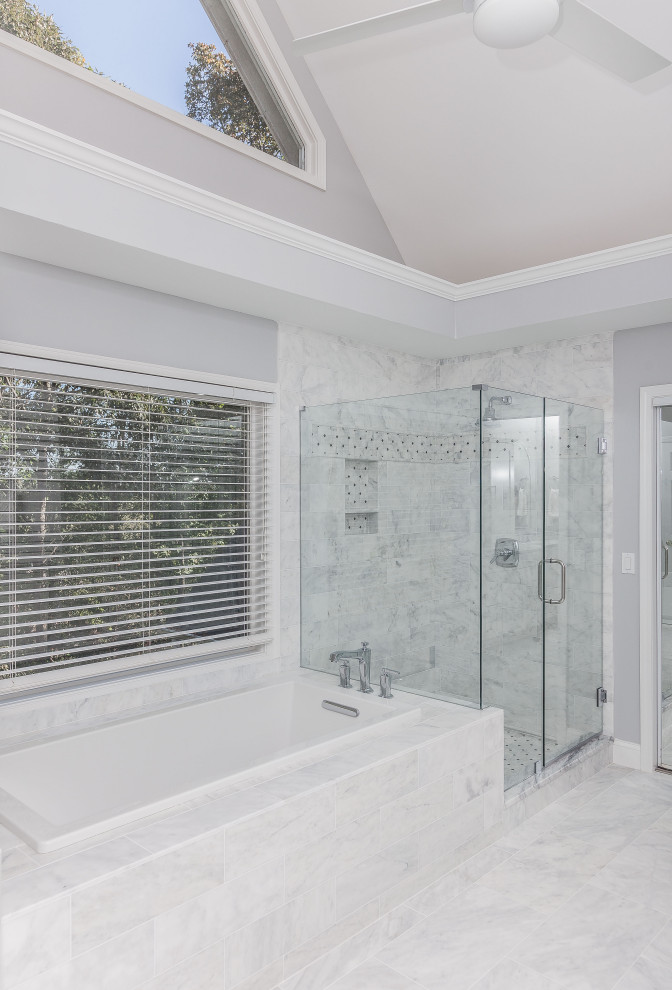 Photo of a large contemporary master bathroom in Atlanta with shaker cabinets, white cabinets, a drop-in tub, an open shower, a two-piece toilet, white tile, marble, grey walls, marble floors, an undermount sink, quartzite benchtops, white floor, a hinged shower door, white benchtops, a niche, a double vanity, a built-in vanity and vaulted.