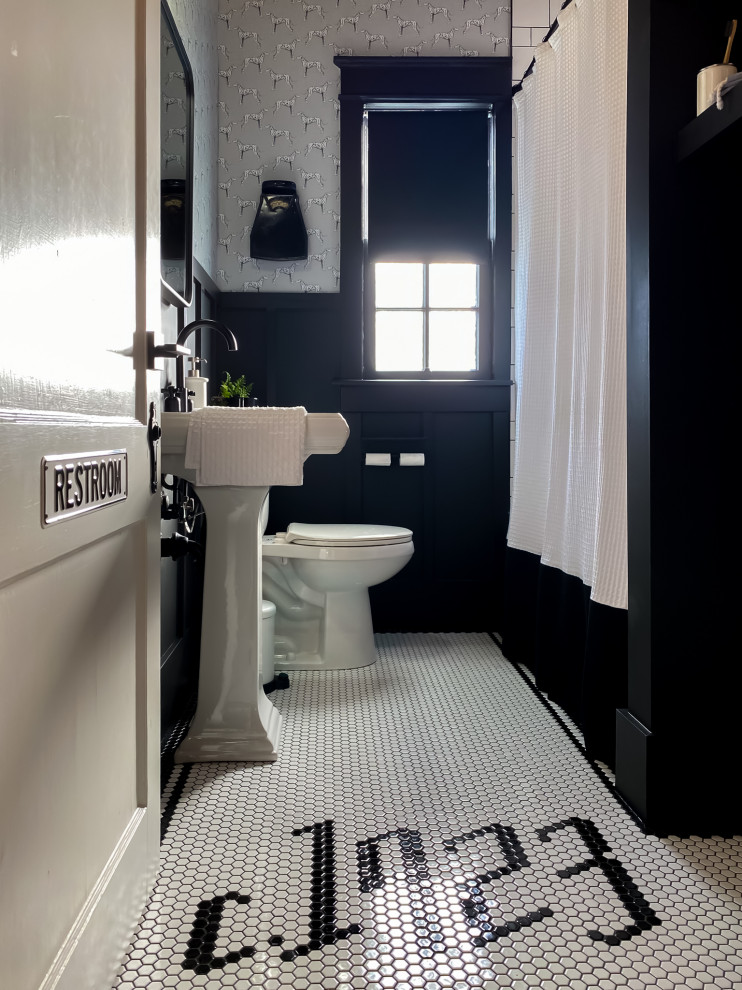This is an example of a mid-sized modern kids bathroom in Nashville with white cabinets, a drop-in tub, a shower/bathtub combo, a two-piece toilet, white tile, ceramic tile, black walls, ceramic floors, a pedestal sink, black floor, a shower curtain, a single vanity, a freestanding vanity and wallpaper.