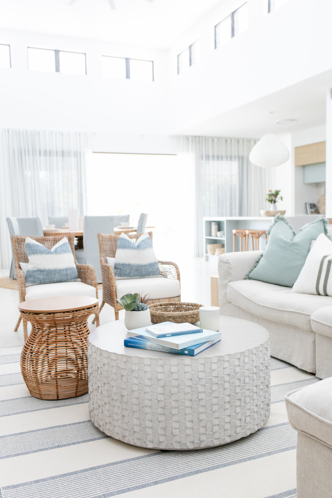 Large beach style open concept living room in Gold Coast - Tweed with white walls.