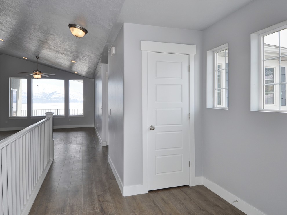 Small arts and crafts foyer in Salt Lake City with grey walls, laminate floors, a single front door and a white front door.