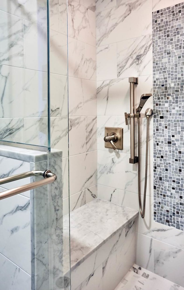 Photo of a mid-sized contemporary master bathroom in New York with an alcove shower, white tile, stone tile, a hinged shower door, white cabinets and white floor.