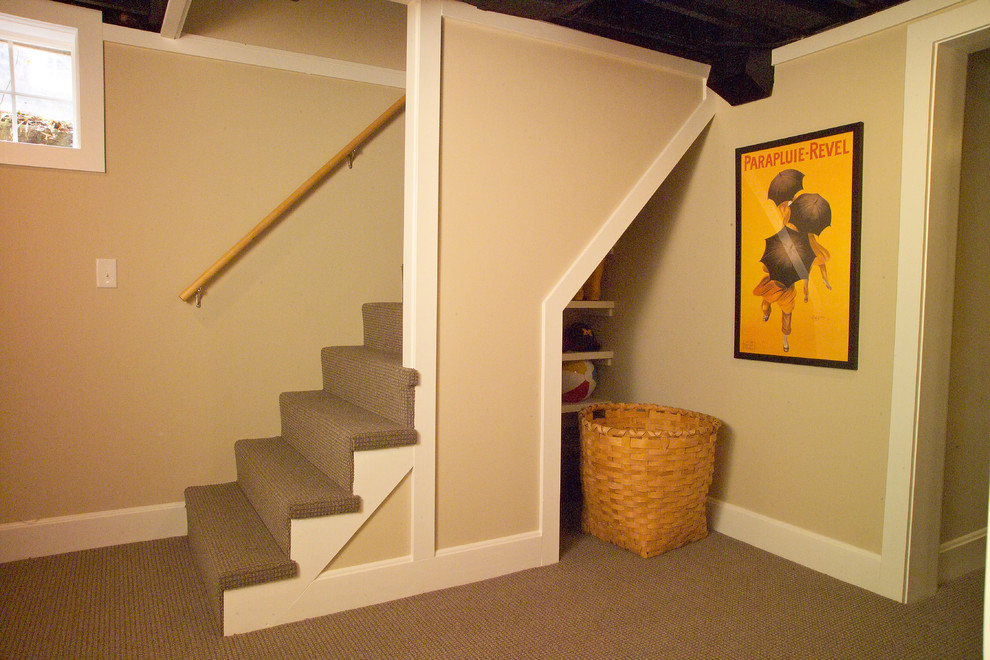 This is an example of a small arts and crafts look-out basement in Detroit with beige walls and carpet.