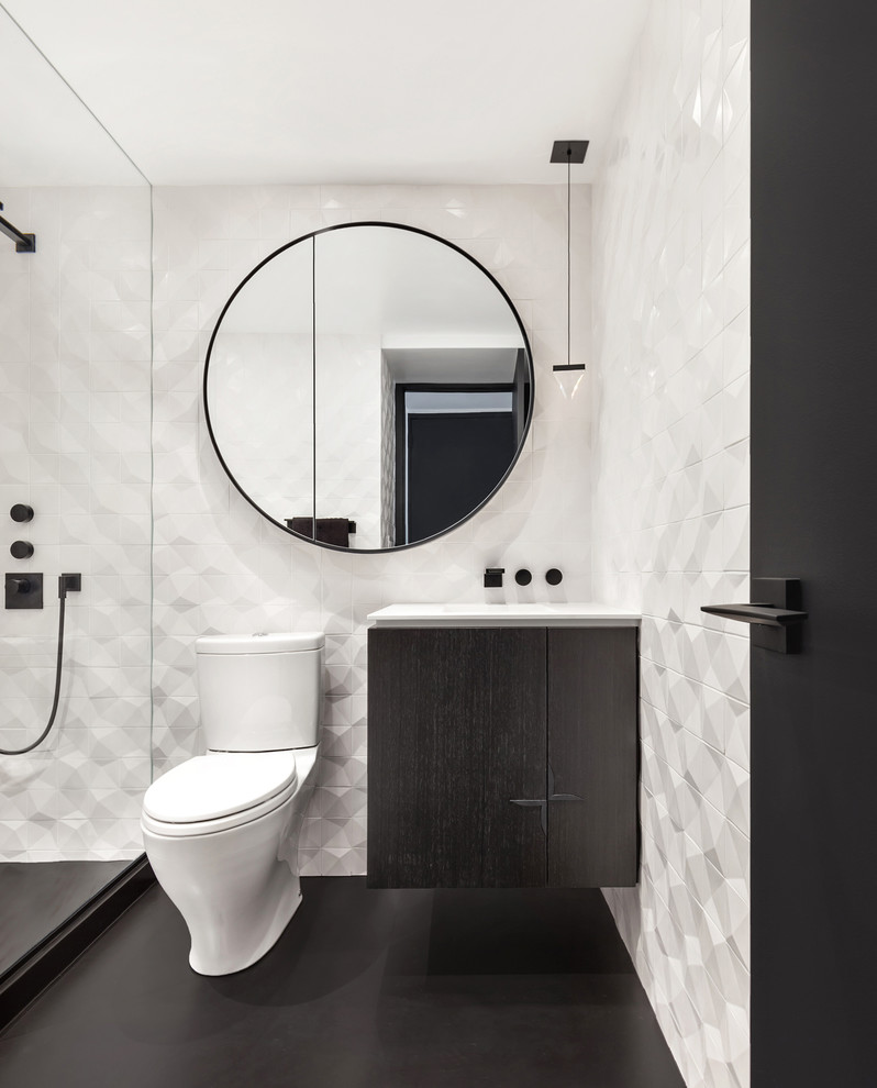 Inspiration for a mid-sized modern master bathroom in New York with flat-panel cabinets, black cabinets, an open shower, a two-piece toilet, white tile, ceramic tile, concrete floors, an integrated sink, solid surface benchtops, black floor and an open shower.