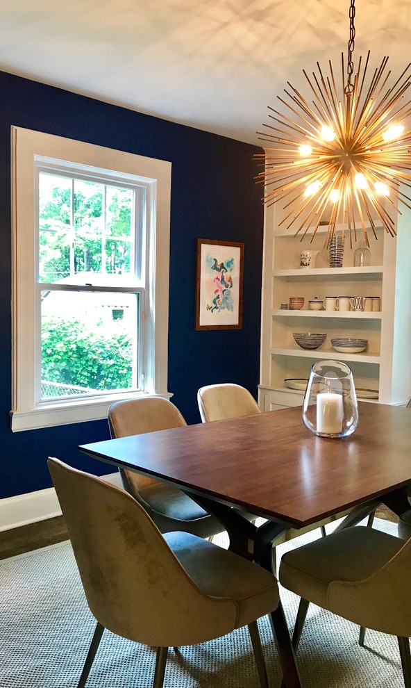 Design ideas for a small eclectic separate dining room in New York with blue walls and dark hardwood floors.