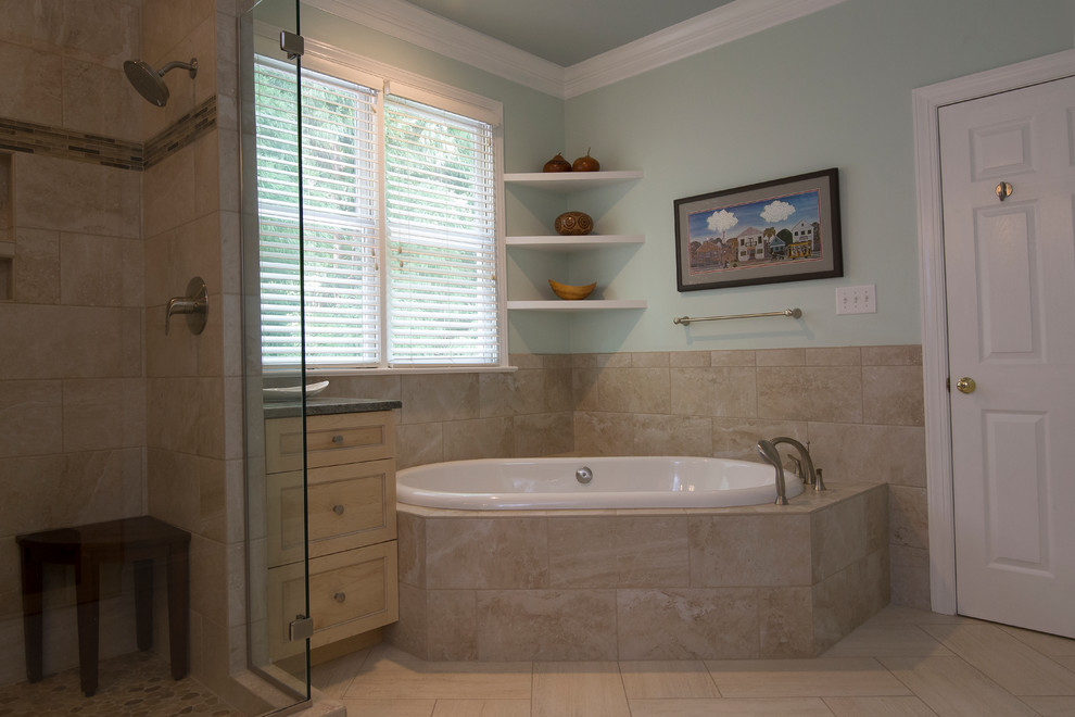 Inspiration for a large transitional master bathroom in Raleigh with light wood cabinets, a drop-in tub, a two-piece toilet, porcelain tile, green walls, porcelain floors, an undermount sink, granite benchtops, shaker cabinets, a corner shower, beige tile, beige floor, a hinged shower door and green benchtops.