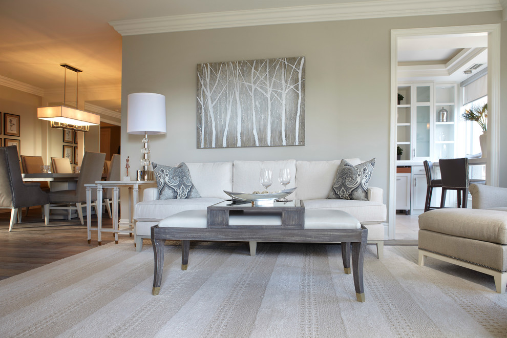 This is an example of a mid-sized transitional open concept family room in Toronto with grey walls and light hardwood floors.