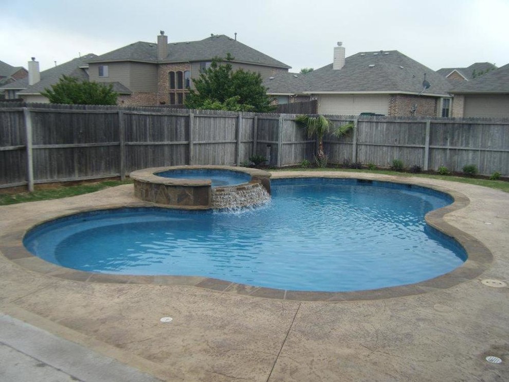 Inspiration for a large transitional backyard custom-shaped and stamped concrete pool fountain remodel in Dallas