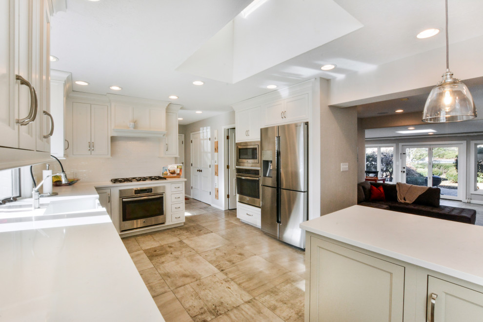 Inspiration for a transitional kitchen remodel with white cabinets and an island