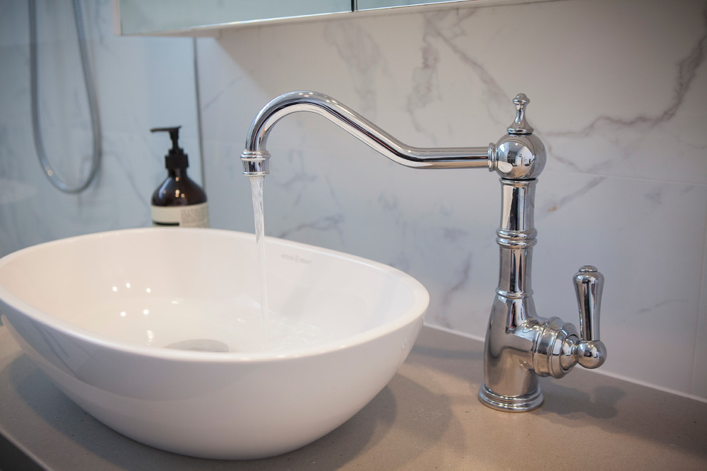 Inspiration for a mid-sized transitional master bathroom in Sydney with shaker cabinets, white cabinets, an open shower, a wall-mount toilet, brown tile, porcelain tile, white walls, porcelain floors, a vessel sink and engineered quartz benchtops.