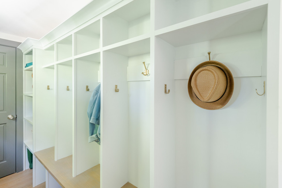 Mudroom - small transitional light wood floor, brown floor and wall paneling mudroom idea in Boston with gray walls