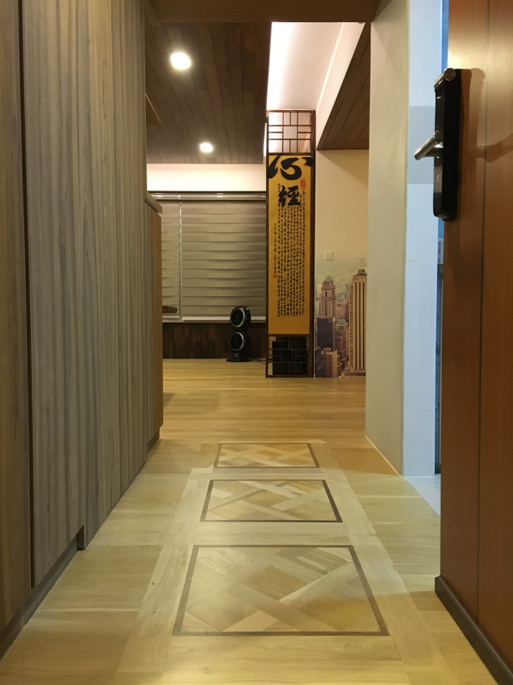 Country entryway in Singapore with light hardwood floors, a brown front door, beige floor, wood and wood walls.