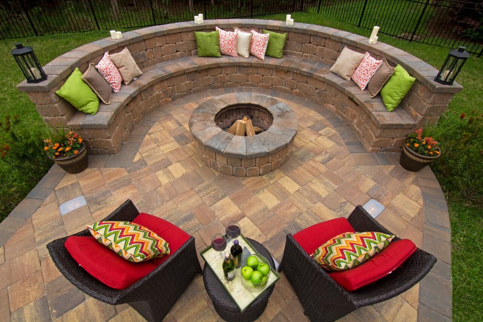 This is an example of a small contemporary backyard patio in Jacksonville with a fire feature, brick pavers and no cover.