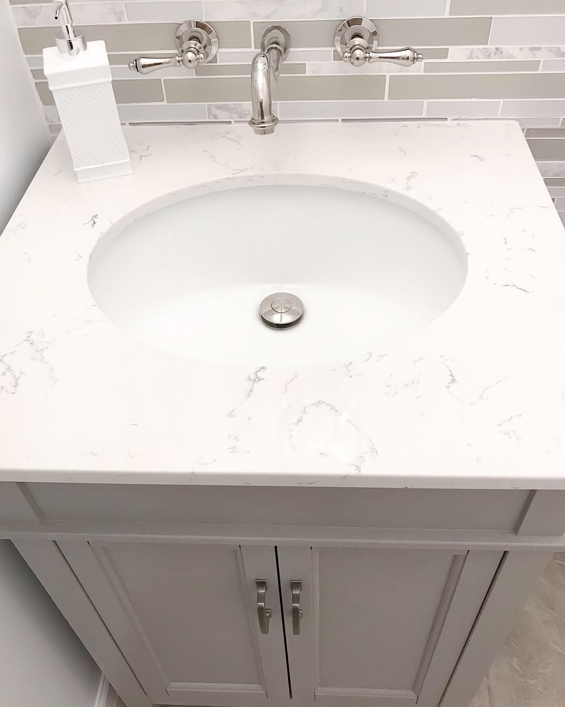 Inspiration for a small transitional powder room in DC Metro with recessed-panel cabinets, grey cabinets, a one-piece toilet, multi-coloured tile, mosaic tile, white walls, an integrated sink, quartzite benchtops and multi-coloured benchtops.