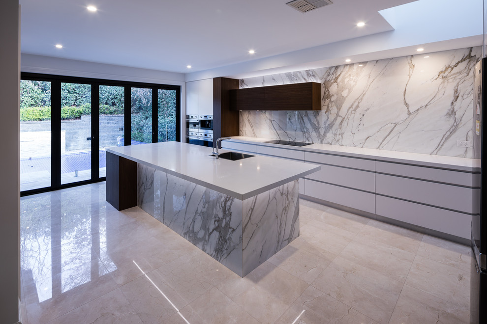 Design ideas for an expansive contemporary single-wall kitchen in Sydney with an undermount sink, flat-panel cabinets, white cabinets, marble benchtops, glass sheet splashback, stainless steel appliances, porcelain floors, with island, multi-coloured floor and multi-coloured benchtop.